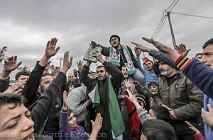 Syrian refugees, one of them holding copy of the Koran, shout Islamic slogans against Assad at Boynuyogun refugee camp in Hatay province in Turkey. Syrian border March 16, 2012.